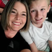 Liz smiling with a young boy